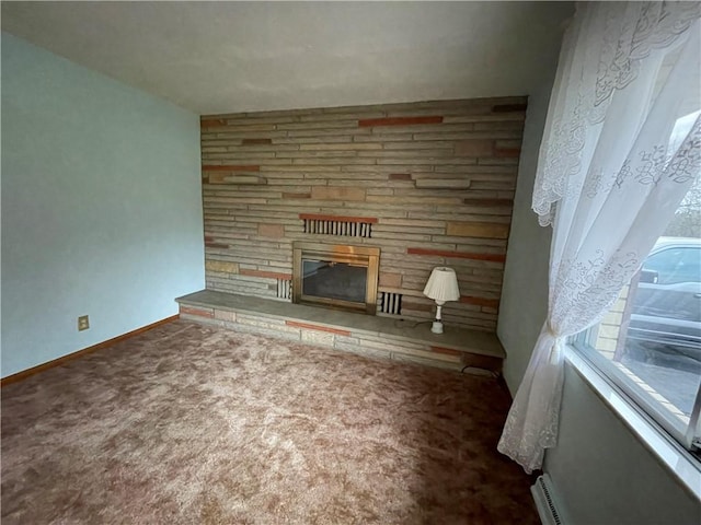 unfurnished living room featuring carpet flooring and a stone fireplace