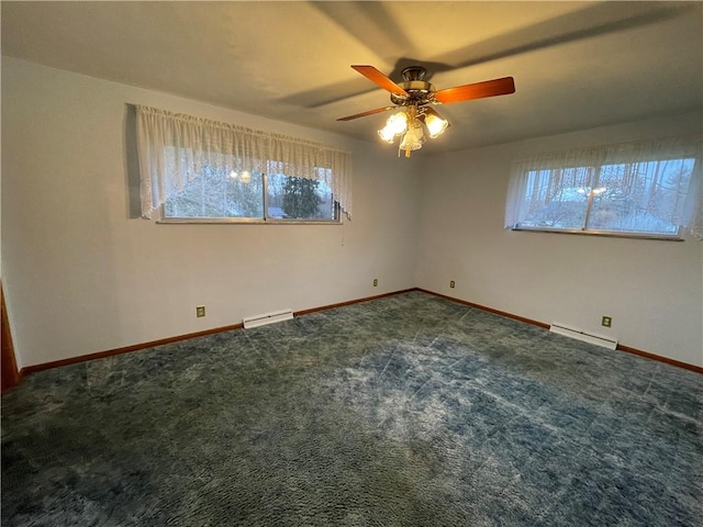 carpeted empty room with ceiling fan, a healthy amount of sunlight, and a baseboard heating unit