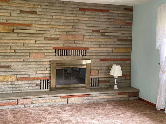 interior space with carpet flooring and a stone fireplace