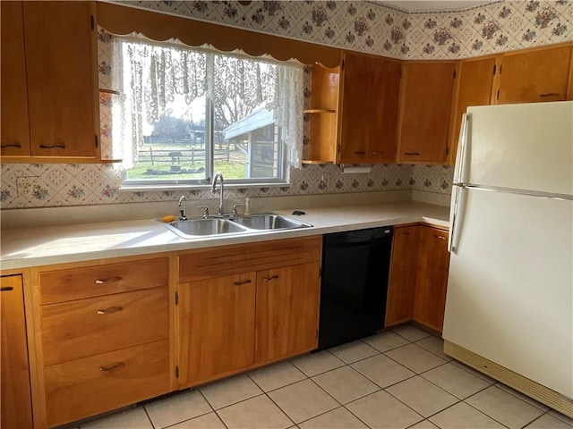 kitchen featuring black dishwasher, light tile patterned floors, white refrigerator, and sink