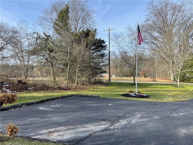 view of basketball court with a lawn