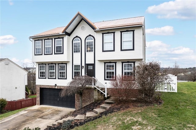 view of front of home with a garage and a front lawn