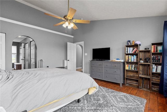 bedroom featuring dark hardwood / wood-style floors, vaulted ceiling, ceiling fan, and crown molding