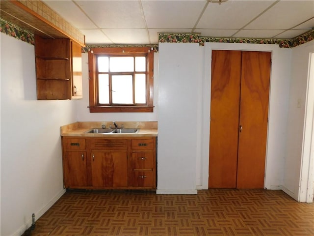 kitchen featuring dark parquet floors and sink