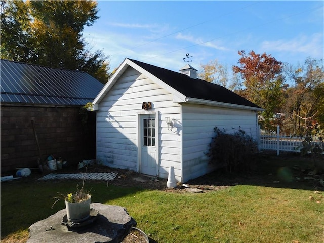 view of outbuilding with a lawn