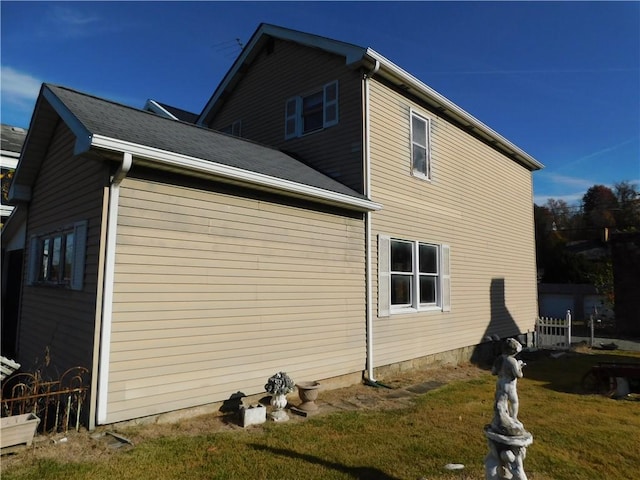 view of property exterior featuring a lawn