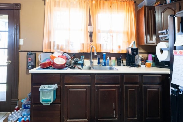 kitchen featuring dark brown cabinets, sink, and plenty of natural light