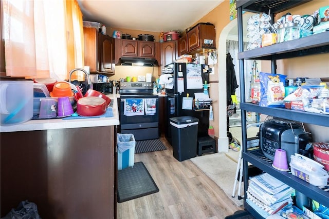 kitchen featuring light wood-type flooring and stainless steel range with electric cooktop