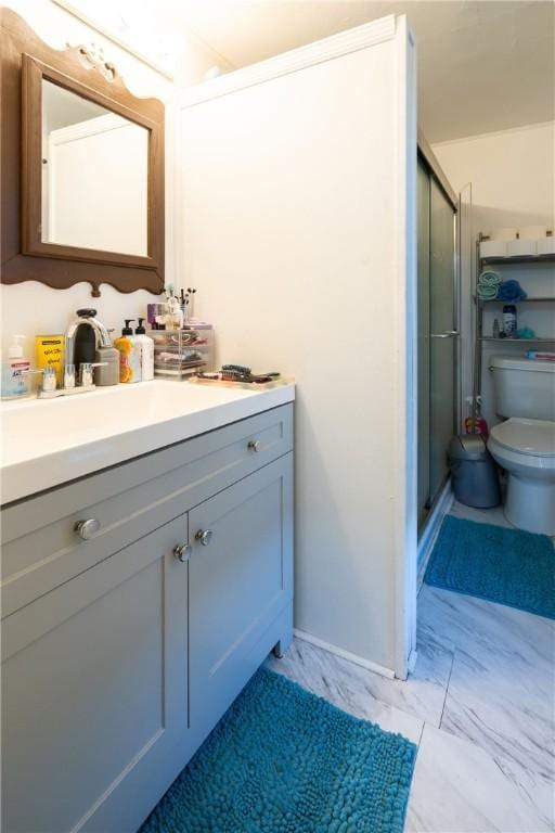 bathroom with vanity, an enclosed shower, and toilet