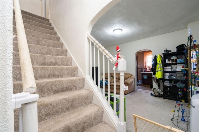 stairway with a textured ceiling