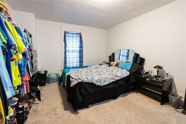 bedroom featuring light carpet