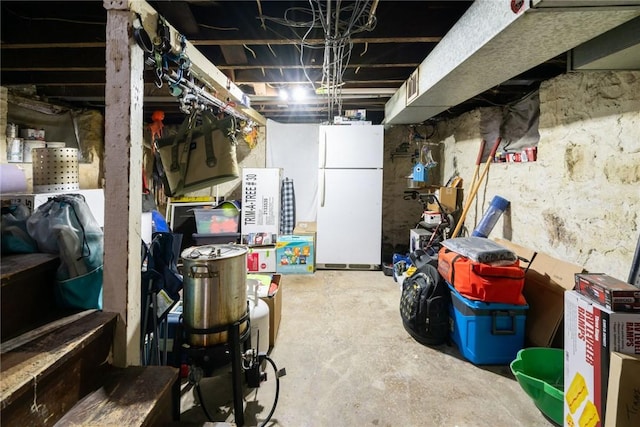 basement featuring white fridge