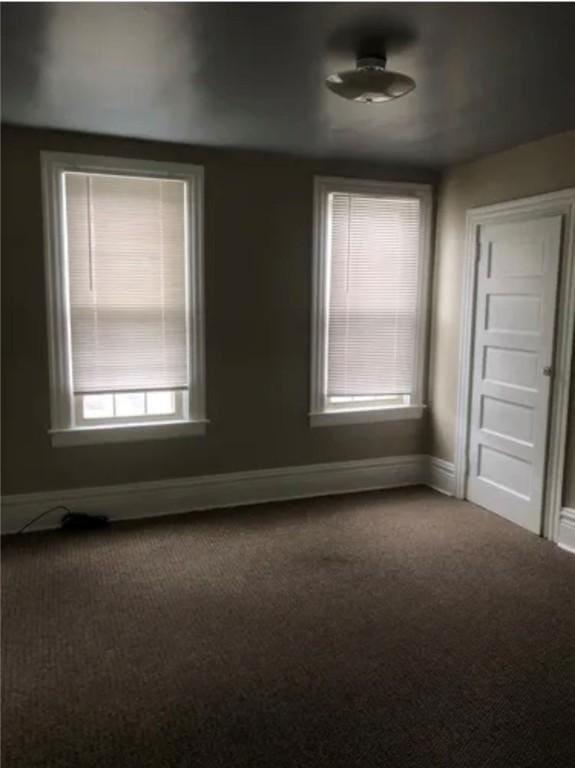 empty room featuring carpet and plenty of natural light