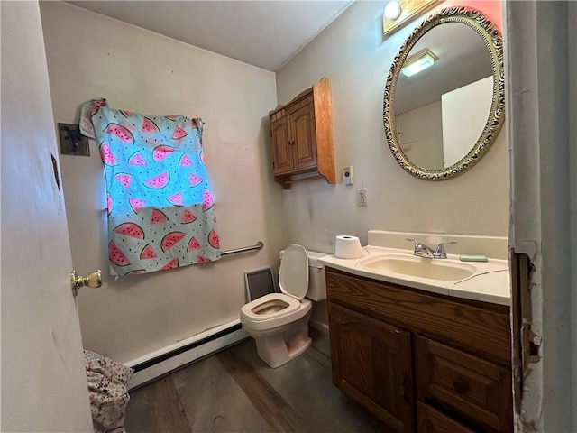 bathroom featuring vanity, toilet, wood-type flooring, and a baseboard radiator