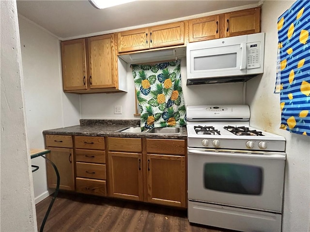 kitchen featuring sink, dark hardwood / wood-style floors, and white appliances