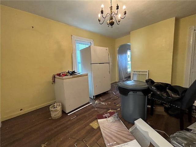 kitchen with plenty of natural light, white fridge, refrigerator, and an inviting chandelier