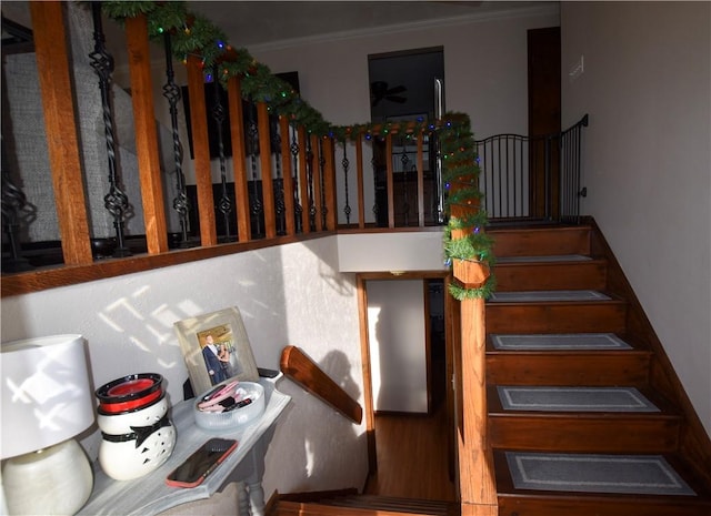 stairway featuring crown molding