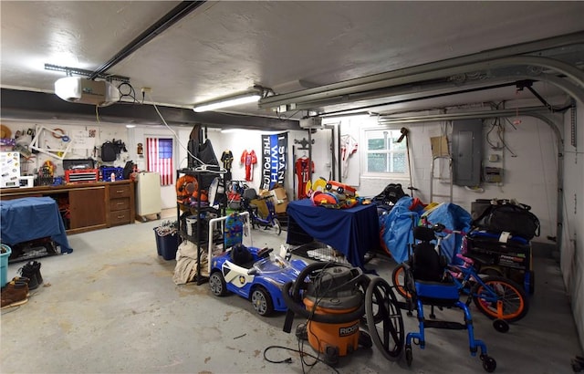 garage with a workshop area, electric panel, and a garage door opener