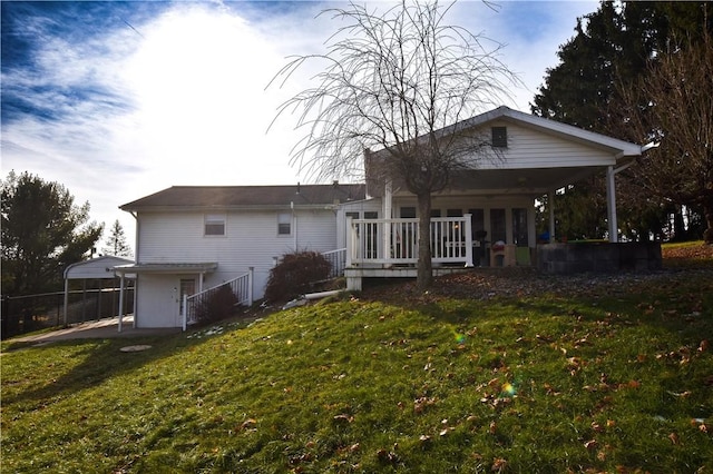 rear view of property featuring a yard