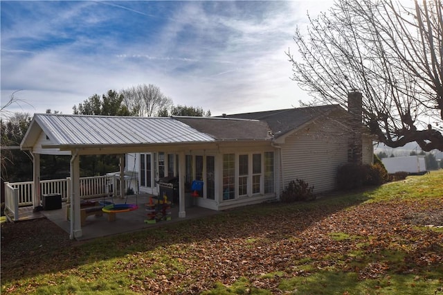 rear view of house featuring a patio