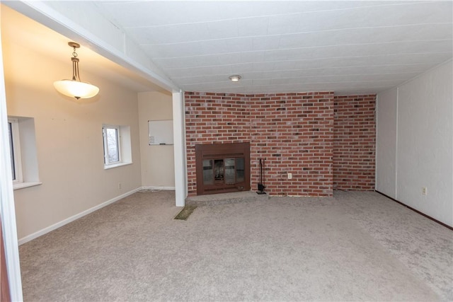 unfurnished living room with vaulted ceiling, carpet floors, and a brick fireplace