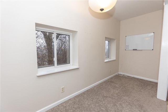 carpeted empty room with a wealth of natural light