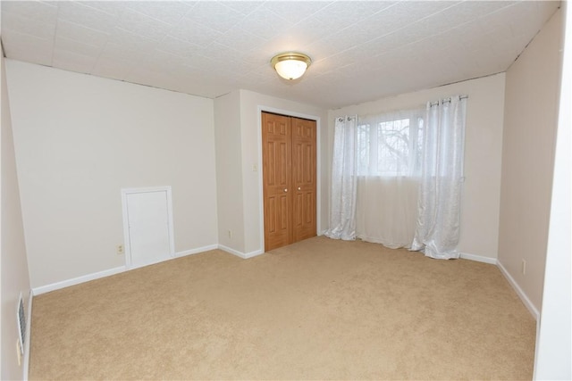 unfurnished room with light colored carpet