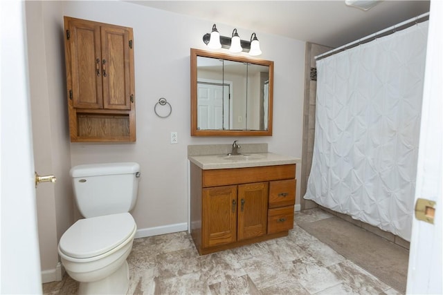 bathroom with vanity, toilet, and walk in shower