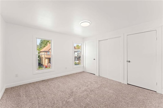 unfurnished bedroom with light colored carpet