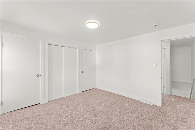 unfurnished bedroom with light carpet