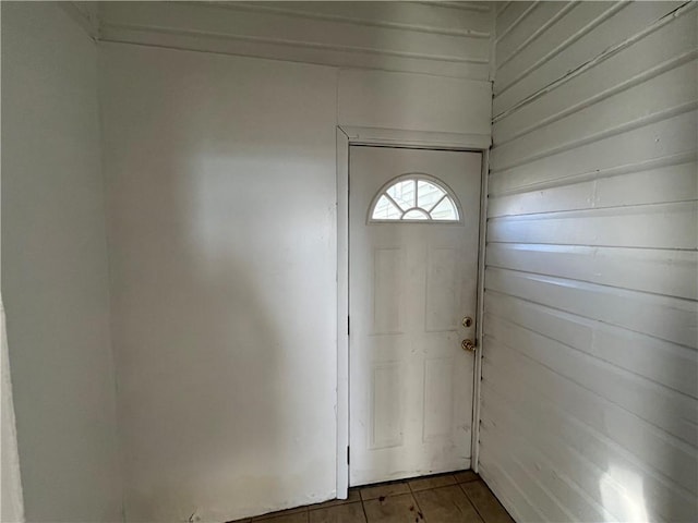 entryway featuring wood walls