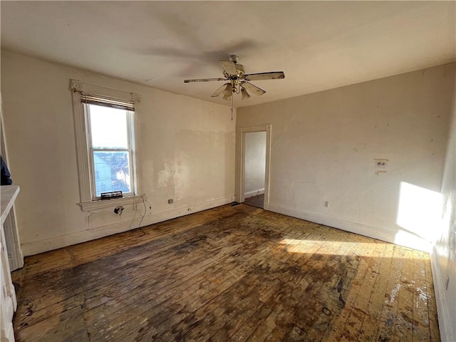 spare room featuring ceiling fan and dark hardwood / wood-style floors