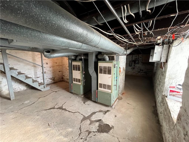 basement with electric panel and heating unit