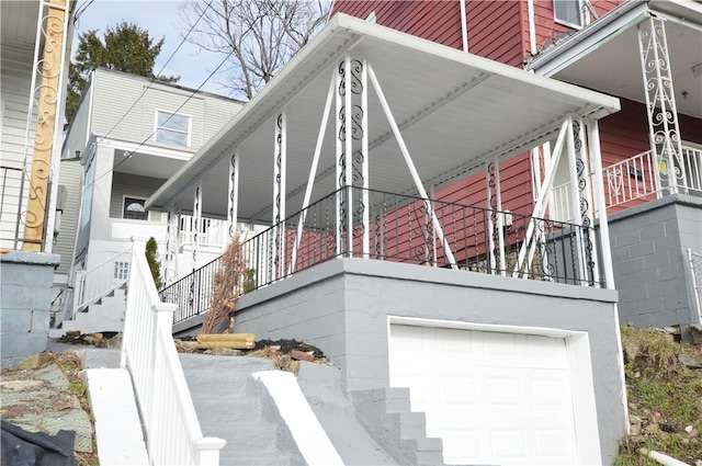 view of home's exterior featuring a porch and a garage