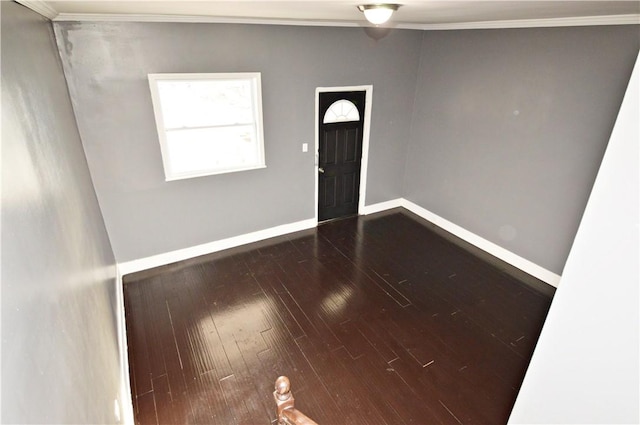 unfurnished room featuring wood-type flooring and crown molding