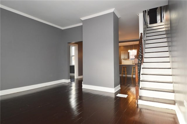 empty room featuring dark hardwood / wood-style floors and crown molding