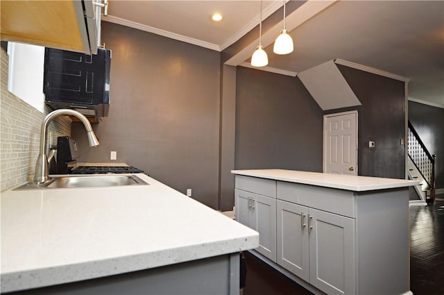 kitchen featuring decorative light fixtures, gray cabinets, ornamental molding, and sink