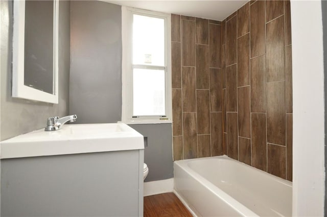 full bathroom featuring hardwood / wood-style flooring, plenty of natural light, shower / bathtub combination, and toilet