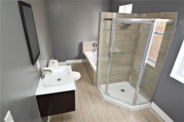 bathroom with vanity, toilet, and a shower with door