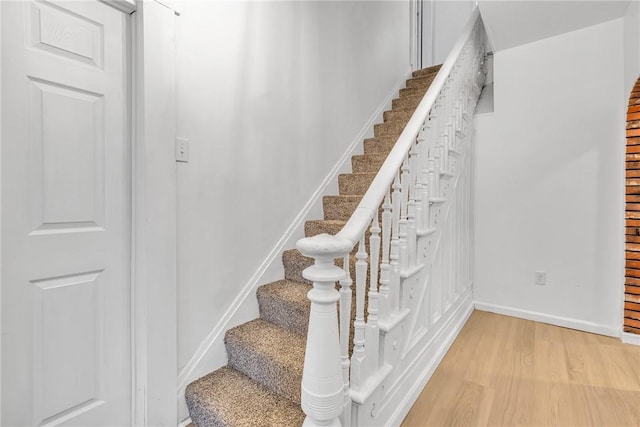 staircase featuring wood-type flooring