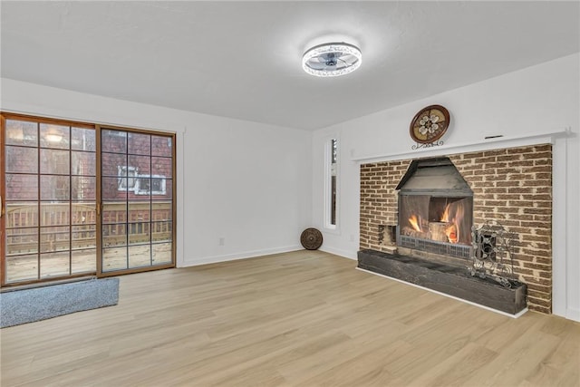 unfurnished living room featuring a fireplace and light hardwood / wood-style flooring