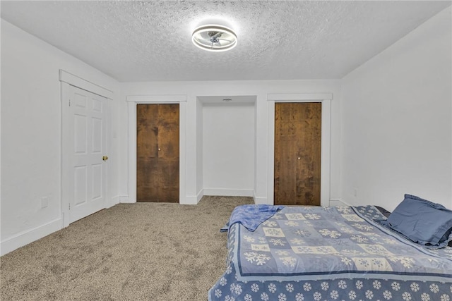 carpeted bedroom with a textured ceiling