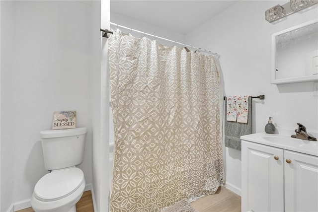 bathroom with curtained shower, vanity, wood-type flooring, and toilet