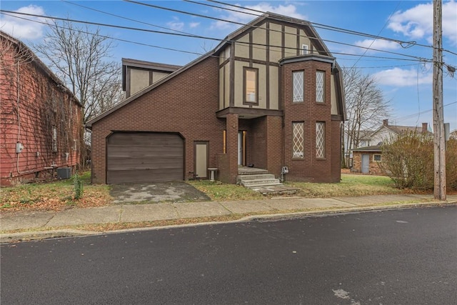 view of front of property with central AC unit and a garage