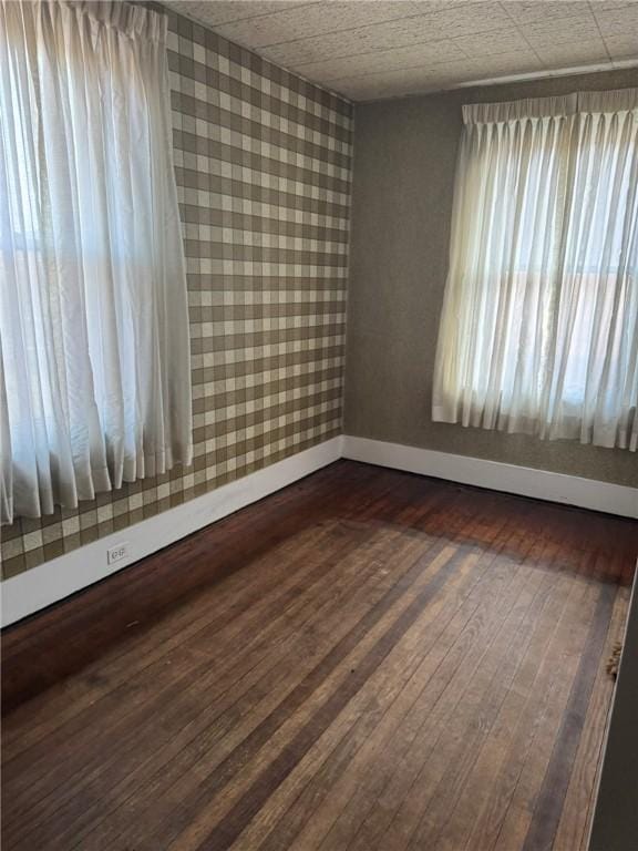 spare room with dark wood-type flooring