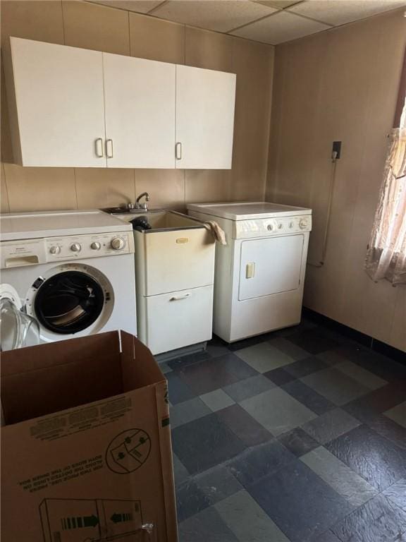 laundry room featuring washing machine and dryer, sink, and cabinets