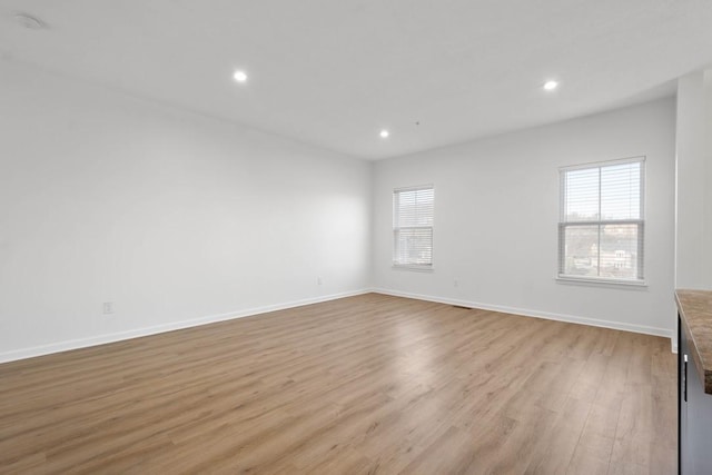 empty room with a healthy amount of sunlight and light wood-type flooring