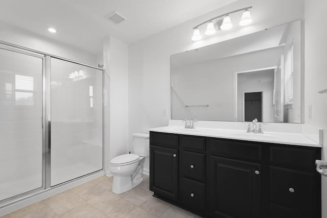 bathroom with toilet, vanity, and walk in shower