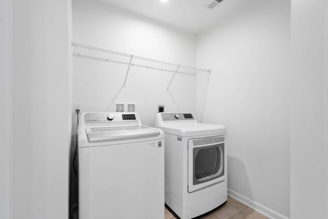 laundry room with independent washer and dryer