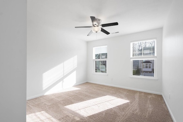 carpeted empty room featuring ceiling fan